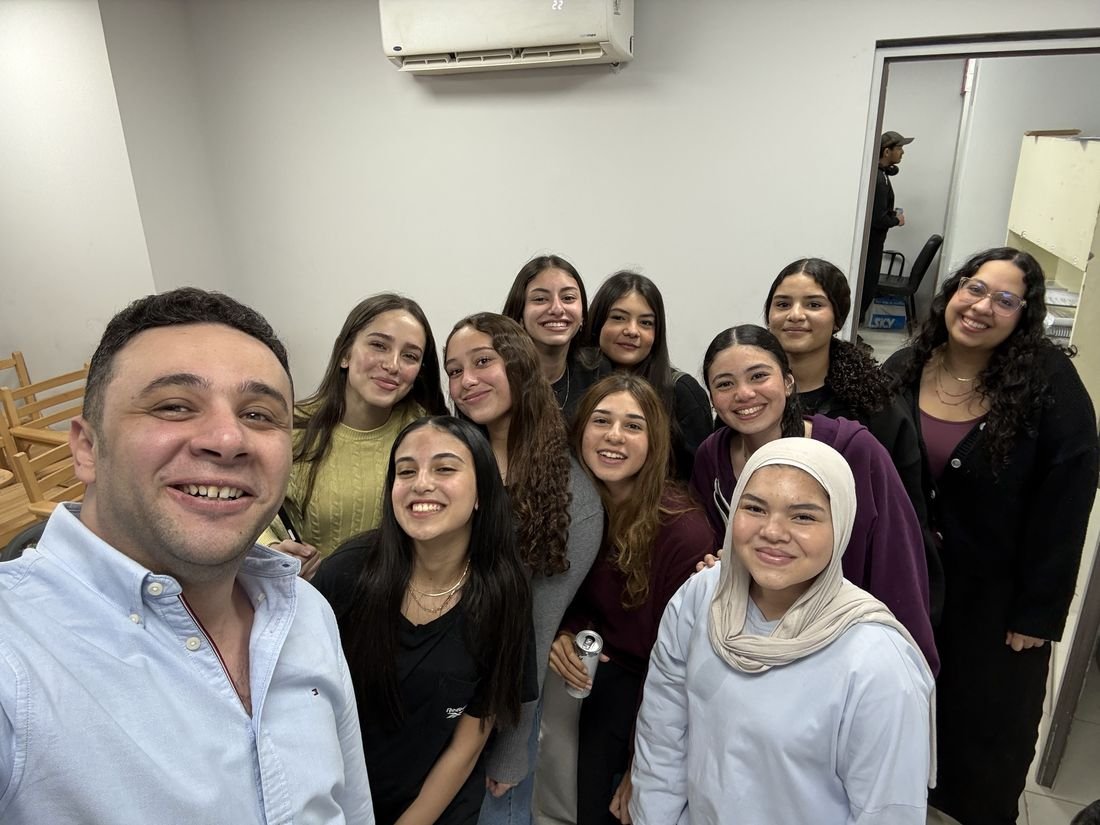 Students smiling with Mr. Karim