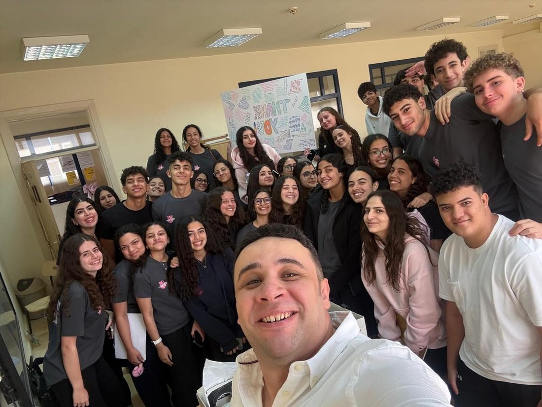 Class presenting a thank-you poster to Mr. Karim